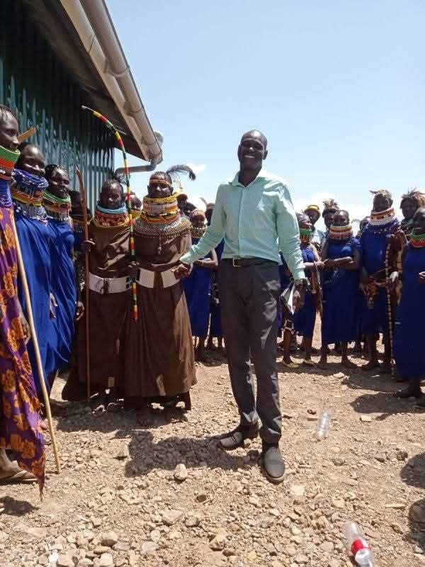 PETRAD AID officer with Turkana community members in traditional attire during peace programme